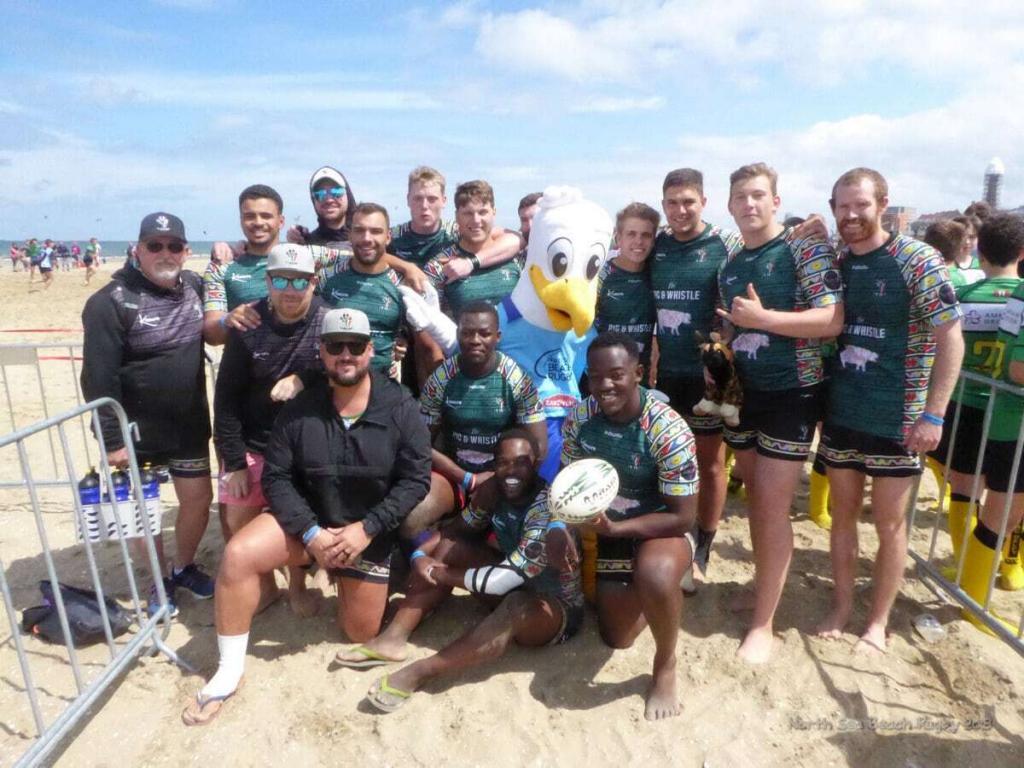 Team South Africa Wild Dogs with Mascot Gullfy at North Sea Beach Rugby in The Hague Beach Stadium in The Netherlands